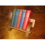 Five language dictionaries on a book rack.