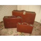 An early 20th century leather suitcase and another, an etch case (3).