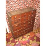 A bank of late 19th/early 20th century chemist drawers.