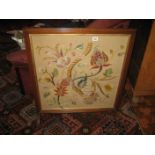 A mahogany framed floral tapestry screen.