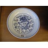 A 20th century chinese blue and white plate with dragon motif.