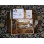 An early 20th century oak tray and assortment of plated cutlery etc.