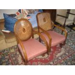 A pair of early 20th century cane back chairs.