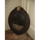 An early relief carved oak mirror.