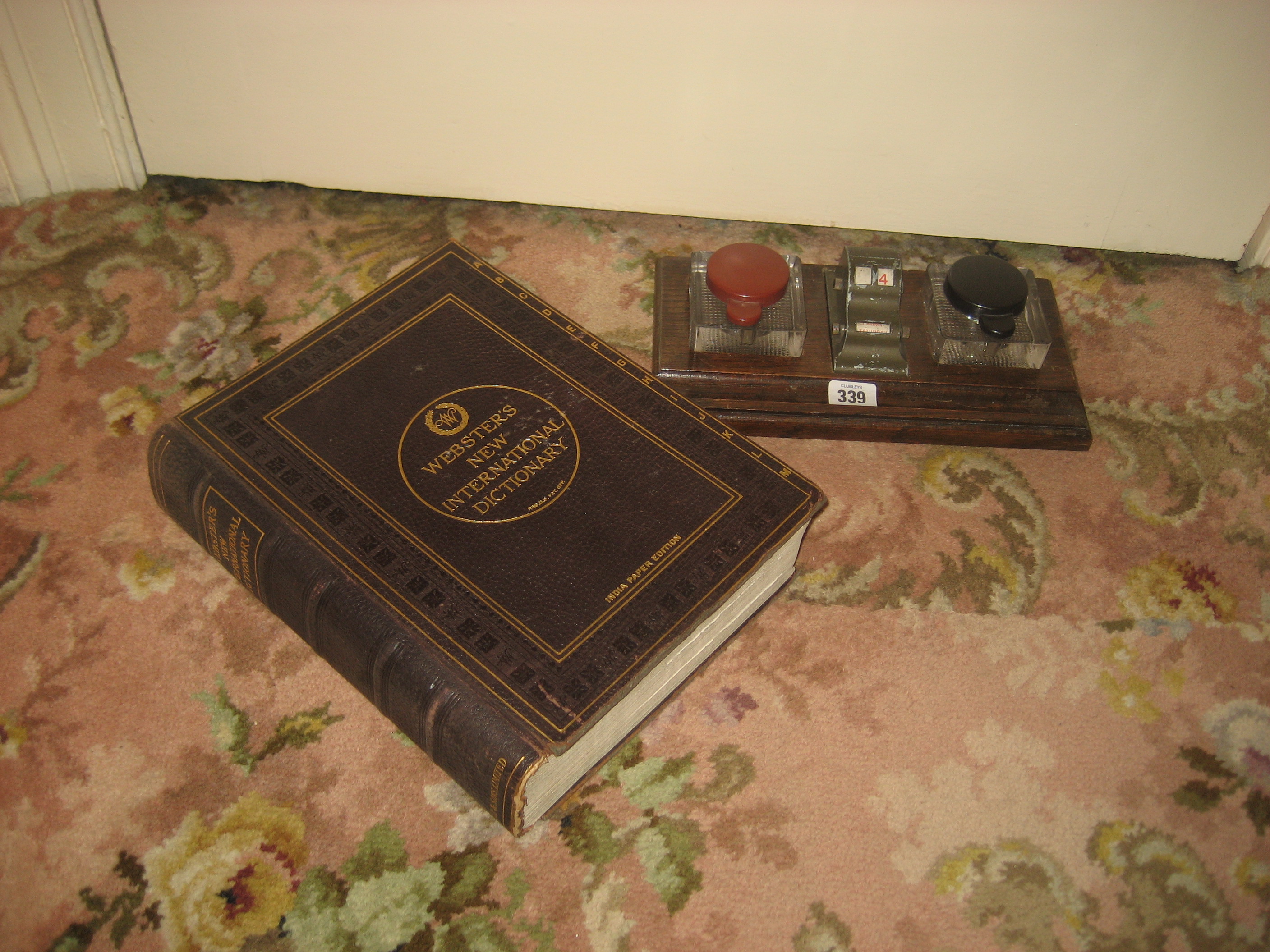 A desk calendar stand and a Websters international dictionary (2).