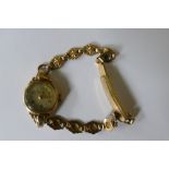 A ladies 18 Jewels 9ct gold watch on associated gold plated strap.