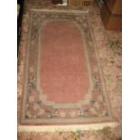 A modern pink ground rug, approx. 165cm x 90cm.