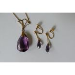 A 9ct gold amethyst pendent on an associated yellow metal chain. A pair of 9ct gold amethyst