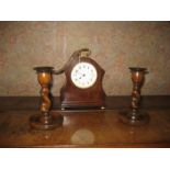 An Elkington mahogany inlaid timepiece and a pair of oak barley twist candle sticks (3).