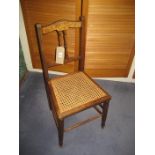 An Edwardian cane seat bedroom chair.