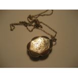 A mid 19th yellow metal locket on associated chain (untested).