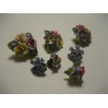 Three ceramic brooches and two sets of earrings (5).