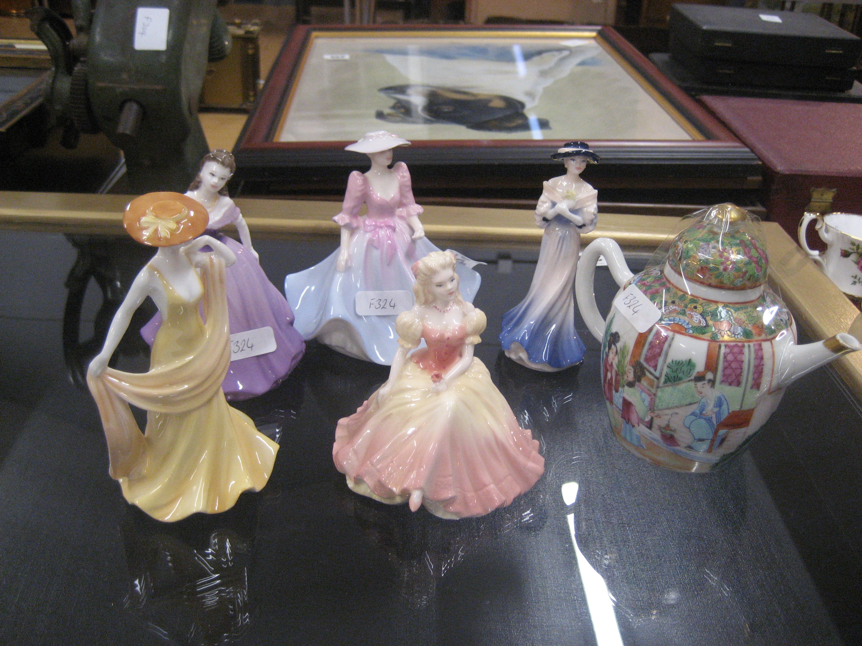 A collection of Coalport figurines and a teapot (5).