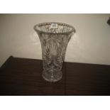 A large cut glass vase with weighted base