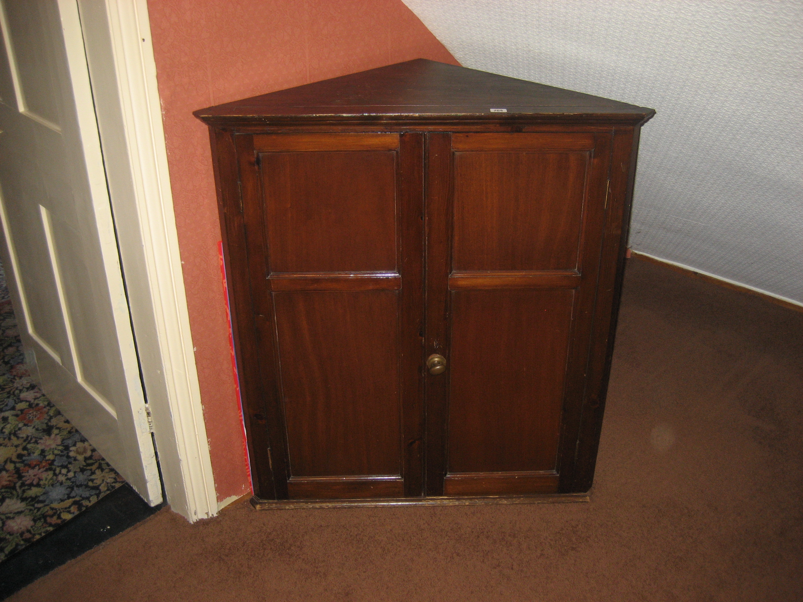 A 20th century mahogany corner cupboard.