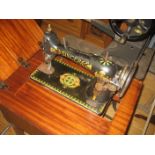 Singer sewing machine in teak cabinet