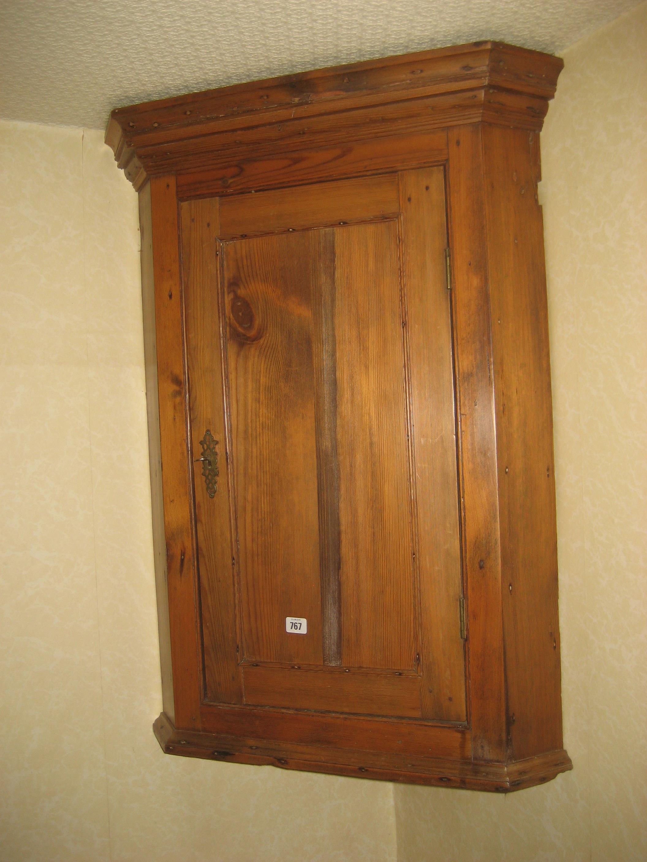 A pine corner cupboard.