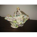 A 20th century posy basket with extensive floral decoration in relief, castle scene to base