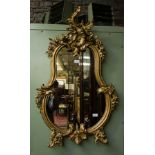 SHAPED ORNATE GILT MIRROR