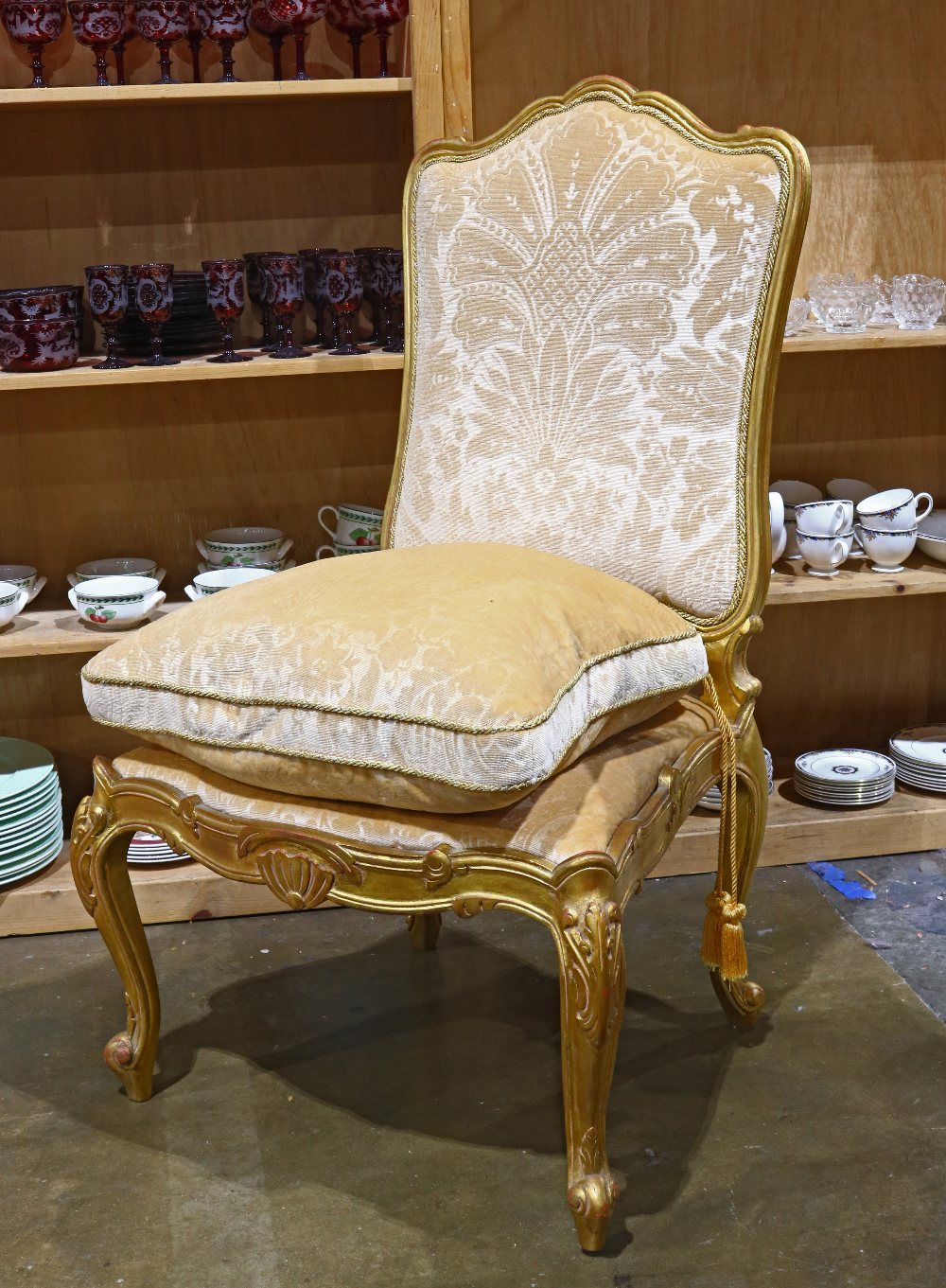 Louis XV style hall chair, having a carved crest above the high back, with a loose down cushion, and