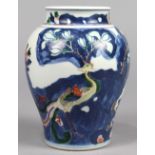 Chinese wucai porcelain jar, with a phoenix amid garden rocks accented by peonies and magnolia, 6"h;