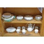 Two shelves of Wedgwood porcelain table items, primarily in the "Windsor Black" pattern,