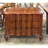 Baroque style commode, by Baker Furniture, having a shaped top over the three drawer case and rising