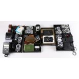 One shelf of assorted photography equipment and accessories, primarily consisting of light meters,