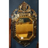 Venetian style mirror, having a bevelled and floral decorated frame surrounding the central panel