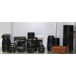 One shelf of photography equipment, consisting of assorted lenses and lens cases, lenses include (2)