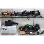 Two shelves of assorted cameras, including a Zenza Bronica camera body, with a 75mm lens, a Nikon