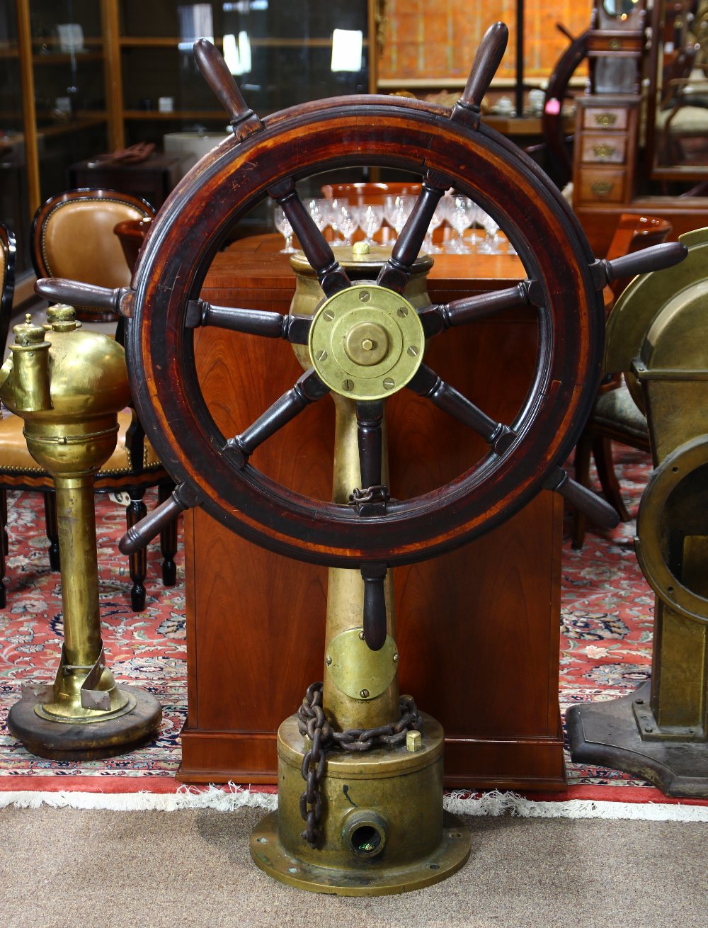 Yacht helm circa 1920, with rudder angle indicator, executed in bronze and brass, mounted with