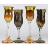 (lot of 4) Art glass stemware group, each having an iridescent bowl, two rising on a turned stem and