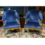 Pair of George II style giltwood wing-back armchairs, 20th century, having a dark blue upholstered