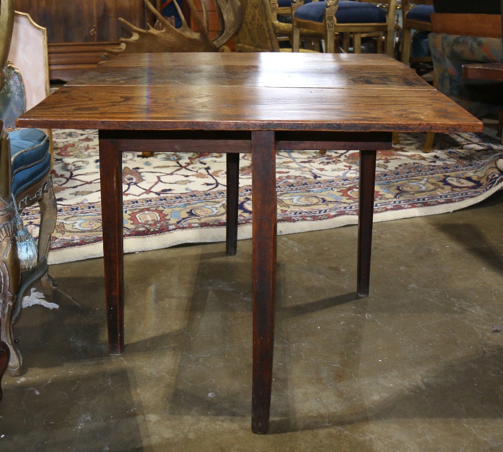 Elm drop leaf table, having a hinged rectangular top over the one drawer case, 27.5"h x 40"w x 37"