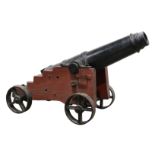 English C W & C ship's cannon, mounted to a wood base with iron wheels, 28"h x 47"l. Provenance: