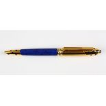 Must de Cartier Panthere roller ball pen, having a yellow gold plated body accented with a lapis