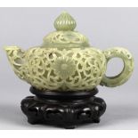 Chinese carved jade teapot, the compressed body high relief carved with floral tendrils, lid with