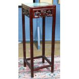 Chinese wooden plant stand, topped with a cloisonne plaque with a bird and flowers on a turquoise