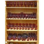 Three shelves of Bohemian glass, executed in ruby red with an acid etched design, consisting of