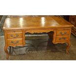 Louis XV style bureau plat, having a parquetry decorated top above the four drawer case, and