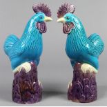 Chinese porcelain roosters, each with a turquoise body standing on an abugerine plinth, 9.75"h