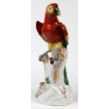 Dresden porcelain sculpture, depicting a Macaw parrot perched at the top of a truncated tree trunk