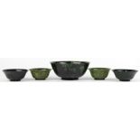 (lot of 5) Chinese hardstone bowls, executed from a mottled dark spinach green matrix, each with