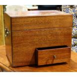 Campaign style box, having a hinged lid opening to the fitted interior, surmounting the lower