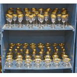 Two bins of partial gilt stemware, including red wine glasses, champagne bowls, cordials, etc.,