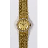 Omega diamond and 18k yellow gold wristwatch Dial: round, gold, applied black baton hours, black