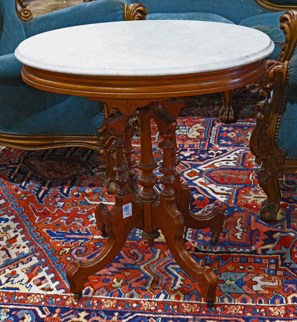 Victorian Eastlake marble top occasional table, having an oval form with stepped skirt, on four