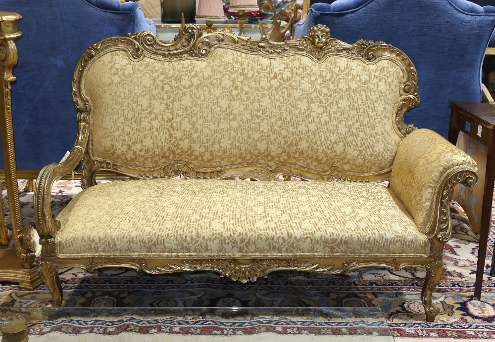 Louis XV style giltwood settee, having an ornately carved crestrail featuring leaf, scroll and