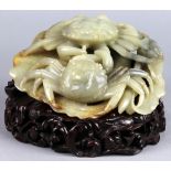 Chinese jade carving, of a pair of crabs, on a lotus leaf, with wood stand, jadeite: 8.25"w